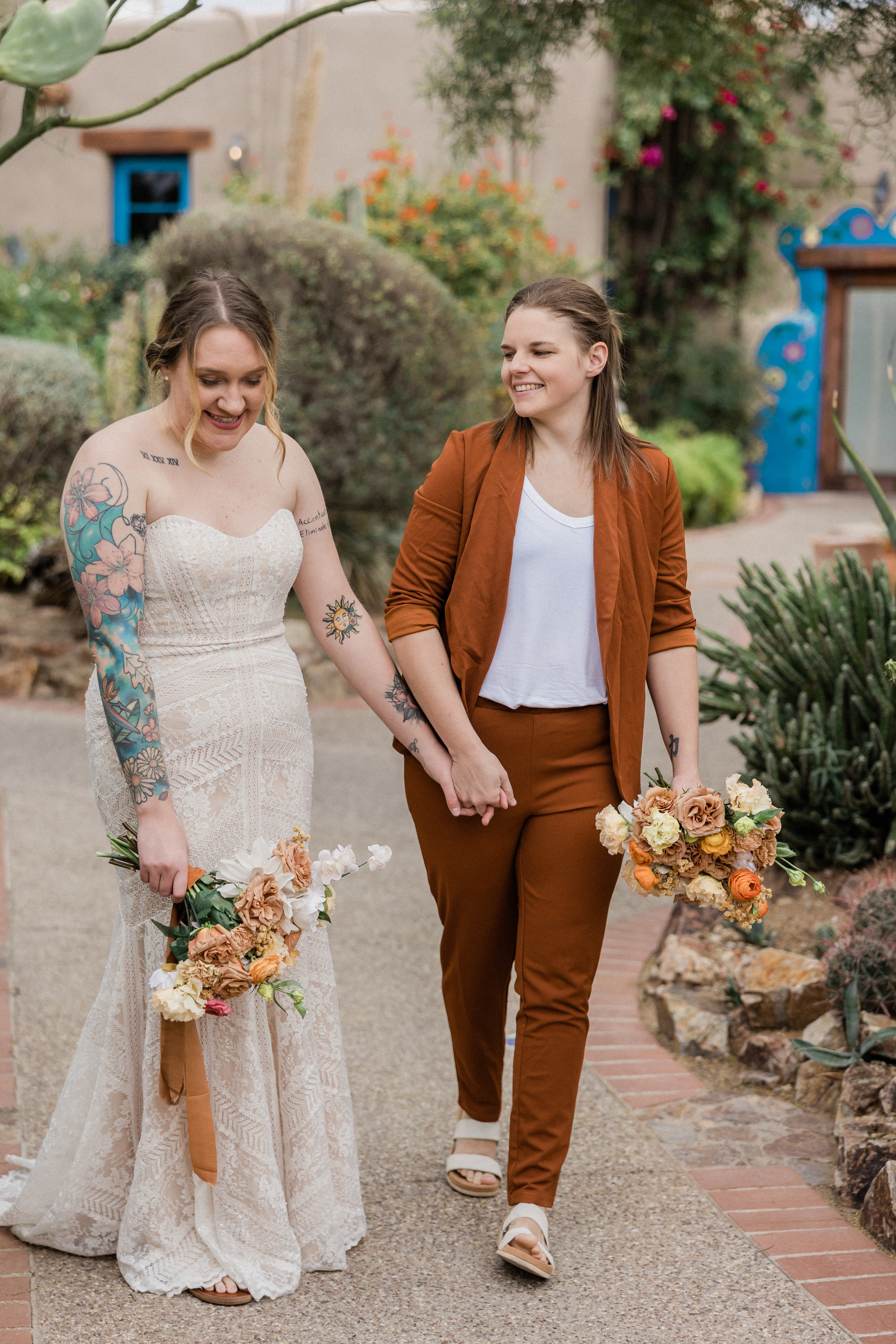 Newlywed Couple Holding Hands Walking at the Pavement